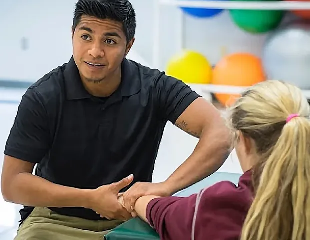 Doctor of Physical Therapy reviewing a treatment plan with a patient
